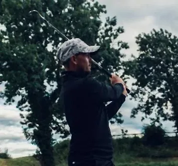 PGA Professional Ash Jones finishing a swing on the course