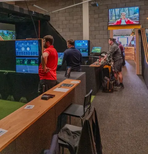 Groups playing across several simulator bays at Virtual Fairways, Darlington