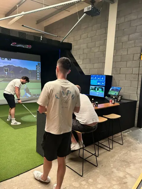 Friends enjoying a relaxed round in a simulator bay at Virtual Fairways, Darlington